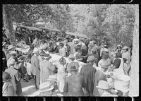 [Untitled photo, possibly related to: Outdoor picnic during the noon intermission of an all-day ministers and deacons meeting. Near Yanceyville, Caswell County, North Carolina]. Sourced from the Library of Congress.