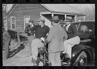 [Untitled photo, possibly related to: Spanish trappers and fur buyers waiting around while muskrats are being graded during auction sale on porch of community store, St. Bernard, Louisiana]. Sourced from the Library of Congress.