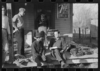 [Untitled photo, possibly related to: Spanish trappers and fur buyers crowd around FSA (Farm Security Administration) supervisor as he opens and reads the bids on that lot of muskrats. The auction sale is on porch of community store, St. Bernard, Louisiana]. Sourced from the Library of Congress.