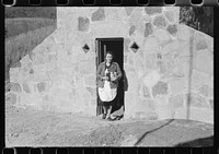 [Untitled photo, possibly related to: Mrs. S. Castle or Mrs. William S. Allen with canned goods in front of new storage house her husband built on their farm with FSA (Farm Security Administration) help. Southern Appalachian project, near Barbourville, Knox County, Kentucky]. Sourced from the Library of Congress.