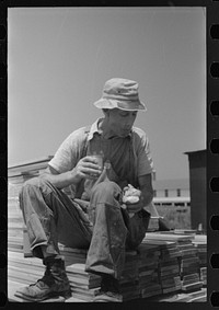 [Untitled photo, possibly related to: Workers during lunch hour putting up prefabricated defense houses managed by FSA (Farm Security Administration), Hartford, Connecticut]. Sourced from the Library of Congress.