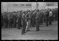 Workers leaving plant at change of shift before being paid off. Electric Boat Works, Groton, Connecticut. Sourced from the Library of Congress.