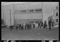 Workers leaving plant at change of shift before being paid off. Electric Boat Works, Groton, Connecticut. Sourced from the Library of Congress.