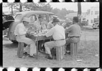 [Untitled photo, possibly related to: Brunswick stew dinner in front of the tobacco warehouse on opening day of the auctions. Prepared by Parent Teachers Association of Prospect Hill, to raise money for a new gymnasium for the Prospect Hill Consolidated School in Caswell County, North Carolina]. Sourced from the Library of Congress.