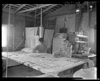 Grandmother from Oklahoma with grandson, working on quilt. California, Kern County. Sourced from the Library of Congress.