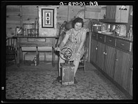 Farmer's wife churning butter. Emmet County, Iowa by Russell Lee