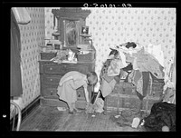 Corner of a bedroom on Edgar Allen farm near Milford, Iowa. There are piles of clothes and rags all over the house. An extreme case of poverty in northwestern Iowa. They are receiving aid from Resettlement Administration by Russell Lee