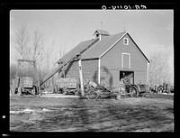 Corn crib on owner-operated farm of G.H. West near Estherville, Iowa. Note wealth of equipment by Russell Lee