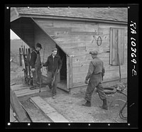 Removing tools from shed during moving operations of Everett Shoemaker, tenant farmer. Near Shadeland Indiana by Russell Lee