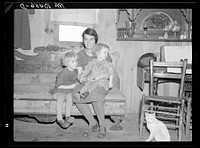 Mrs. Oscar Gaither and two of her five children in their farmhouse near McLeansboro, Illinois. Gaither is a tenant farmer of eighty acres by Russell Lee