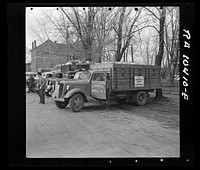 Twenty truckloads of corn were sent as a gift from the farmers of Livingston County, Illinois to southeastern Illinois flood counties. Near Carmi, Illinois by Russell Lee
