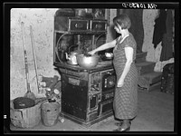 Mrs. Erasty Emrich in her kitchen. Mrs. Emrich is the wife of a tenant farmer and mother of twelve children, eleven of them living. Near Battle Ground, Indiana by Russell Lee