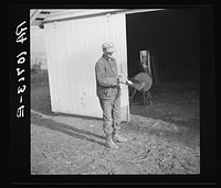 Tip Estes oils the spade before he puts it away. Near Fowler, Indiana by Russell Lee