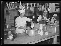 Preparing dinner for the six hundred fifty flood refugees encamped at Tent City near Shawneetown, Illinois by Russell Lee