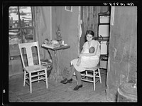 Mrs. Smallwood and her baby in the shack which they share with another family near Alvin, Wisconsin by Russell Lee