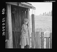 One of William Sharrard's children in the doorway of their home near Silk Lake, Michigan by Russell Lee