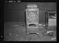 An old slot machine in an abandoned saloon at Mansfield, Michigan by Russell Lee