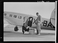 Plant quarantine inspector examining baggage brought into the United States by plane from Mexico. Glendale California. Sourced from the Library of Congress.