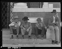 On the steps of the bank in the town square. Memphis, Texas by Dorothea Lange