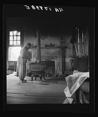 Interior of a plantation house now vacant but for two rooms occupied by an old Negro couple, tenants. Greene County, Georgia by Dorothea Lange