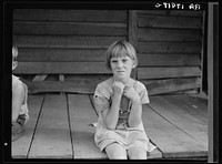 Sharecropper's child whose father receives five dollars a month "furnish" from the landowners. Macon County, Georgia by Dorothea Lange