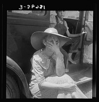 Douglas, Georgia. Wife of sharecropper in town to sell their crop at the tobacco auction by Dorothea Lange