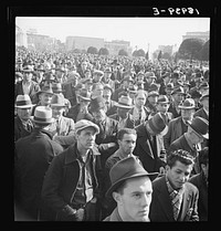 Listening to speeches at mass meeting of Works Progress Administration (WPA) workers protesting congressional cut of relief appropriations. San Francisco, California by Dorothea Lange