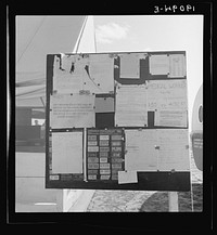 Calipatria, Imperial Valley. Farm Security Administration (FSA) migratory labor camp (emergency). Migratory workers, in camp for pea harvest, scan the bulletin board at entrance. Sourced from the Library of Congress.