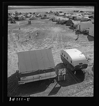 Farm Security Administration (FSA) migratory labor camp. Emergency camp was established to meet the needs of migratory families during the spring pea harvests. 155 families were living here at the time photograph was made. Shows office, playground, and trailer which was built for living quarters and office of the camp manager. The trailer is part of the mobile camp unit. Calipatria, Imperial Valley, California. Sourced from the Library of Congress.