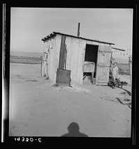 [Untitled photo, possibly related to: Laundry facilities for ten cabins at Arkansawyers auto camp, Salinas Valley, California. Note stove to heat water]. Sourced from the Library of Congress.