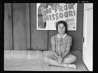Advertisement for current movie in town. Westley, California. The child is a flood refugee of March 1939 from southeast Missouri. Sourced from the Library of Congress.