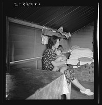 [Untitled photo, possibly related to: Tulare County, California. In Farm Security Administration (FSA) camp for migratory agricultural workers. Mother with sick baby awaits arrival of FSA camp resident nurse]. Sourced from the Library of Congress.