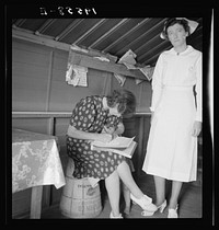 [Untitled photo, possibly related to: Farm Security Administration (FSA) camp. Farmersville, California. Resident nurse interviews mother and examines sick baby]. Sourced from the Library of Congress.