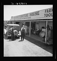 Outskirts of Fresno. On U.S. 99. Many small second businesses and stores on U.S. 99. Approaching Fresno. See general caption. Sourced from the Library of Congress.