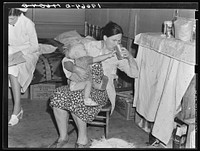 Tulare County, California. In Farm Security Administration (FSA) camp. Mother from Oklahoma tends baby with dysentery and awaits arrival of FSA camp resident nurse. Sourced from the Library of Congress.