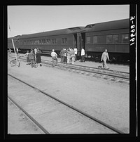 [Untitled photo, possibly related to: Railroad yards, Kearney, Nebraska. Overland train passengers go back to their cars after ten minute train stop on trip between San Francisco and Chicago]. Sourced from the Library of Congress.