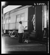 [Untitled photo, possibly related to: Railroad yards, Kearney, Nebraska. Overland train passengers go back to their cars after ten minute train stop on trip between San Francisco and Chicago]. Sourced from the Library of Congress.