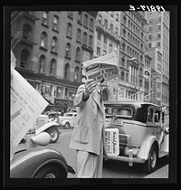 "Social Justice," founded by Father Coughlin, sold on important street corners and intersections. New York City by Dorothea Lange. Sourced from the Library of Congress.