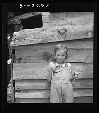 [Untitled photo, possibly related to: Eight year old daughter who helps about the tobacco barn and takes care of the baby. Granville County, North Carolina]. Sourced from the Library of Congress.