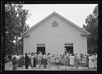 [Untitled photo, possibly related to: Congregation gathers in groups to talk after services are over. Wheeley's Church, Person County, North Carolina] by Dorothea Lange