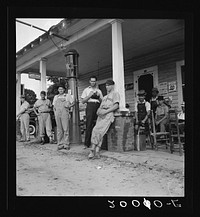 Fourth of July, near Chapel Hill, North Carolina. Rural filling stations become community centers and general loafing grounds. The men in the baseball suits are on a local team which will play a game nearby. They are called the Cedargrove Team. Sourced from the Library of Congress.