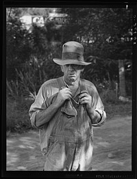 Migratory worker in auto camp. Single man, speaks his mind. "Them WPAs are keeping us from a living. They oughtn't to do it. It ain't fair in no way. The government lays them off (that is in Work Projects Administration - 1939) and they come in because they're locals and take the jobs away from us that never had no forty-four dollars a month. I came out of Pennsylvania, used to be an oil worker. I'm getting along in years now and I seen lots of presidents and lots of systems. Voted for Roosevelt both times and I don't know of any president that ever leaned toward the laboring man like him, but this system they've got here in the fruit is a rotten system the way they work it." Yakima Valley, Washington. Sourced from the Library of Congress.