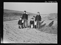 Boys wait for school bus in the morning. Malheur County, Oregon. General caption number 67-1V. Sourced from the Library of Congress.