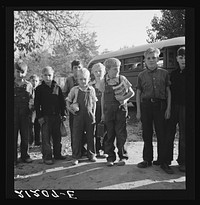 The children from Dead Ox Flat get off bus at school yard. Ontario, Malheur County, Oregon. General caption number 67-1V by Dorothea Lange