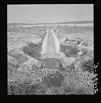 Irrigation canal. Shows drop to go under road. Water has just been shut off for the season. Near Nyssa, Malheur County, Oregon. Sourced from the Library of Congress.