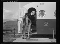 [Untitled photo, possibly related to: Young mother brings her child to the trailer clinic on the day when the doctor will be in camp to examine some of the children. FSA (Farm Security Administration) mobile camp. Merrill, Klamath County, Oregon]. Sourced from the Library of Congress.