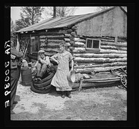 Mrs. Hale and her oldest son in front of their home near Black River Falls, Wisconsin. This farm house was built with a total expenditure of three dollars in money by Russell Lee