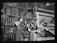 Adjusting the fibre board machine. Timber Mechanics Section, Forest Products laboratory. Madison, Wisconsin by Russell Lee