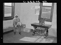 Old resident of corner of beer parlor. Gemmel, Minnesota. Former prosperous lumbering center. Note sign and battery-operated radio by Russell Lee