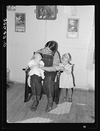 Mrs. Charles Swanson and her two children on farm near Northome, Minnesota by Russell Lee
